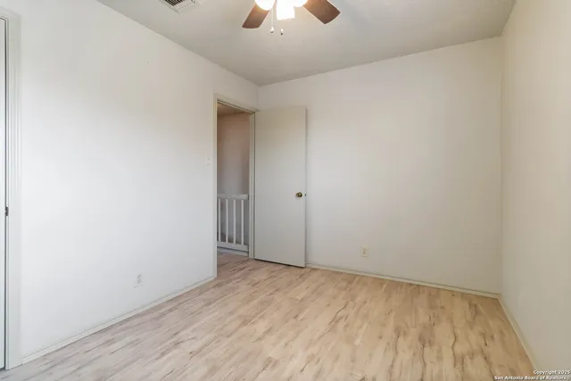 a bathroom with a granite countertop sink and a toilet