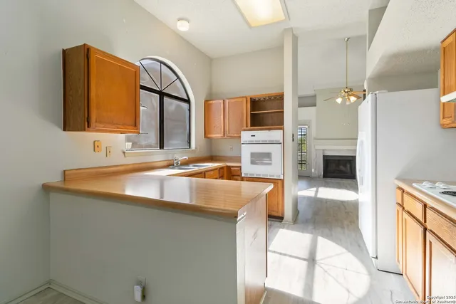a kitchen with stainless steel appliances granite countertop a sink and a stove top oven