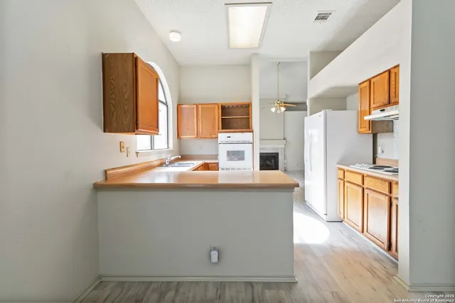 a kitchen with stainless steel appliances a sink stove and refrigerator