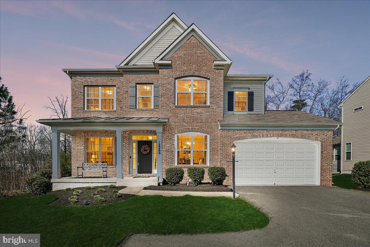12268 Sedge Street Bristow, VA 20136 - Photo 1 of 48 a front view of a house with a yard and garage
