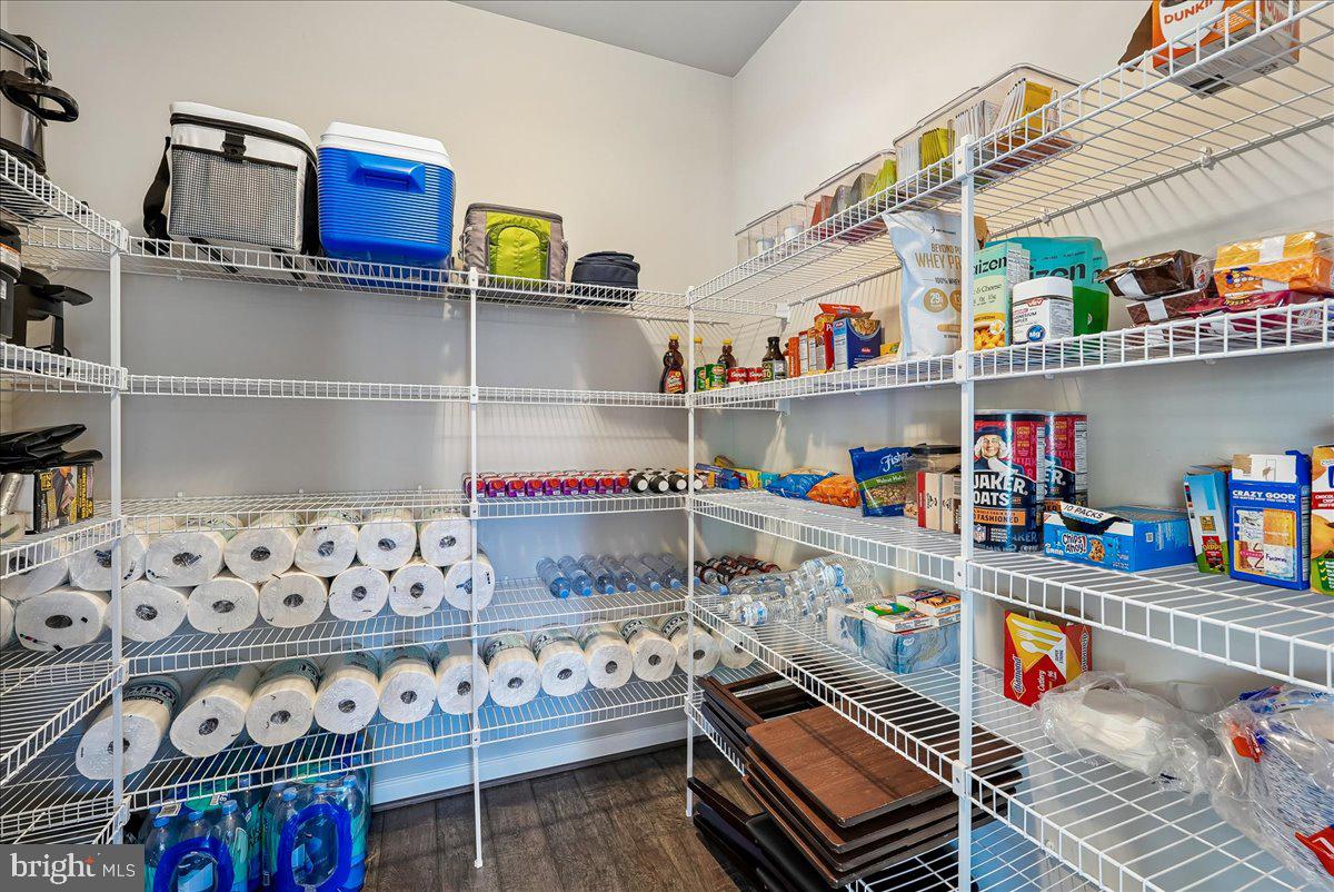 12268 Sedge Street Bristow, VA 20136 - Photo 11 of 48 a kitchen with lots of clutter and cabinets