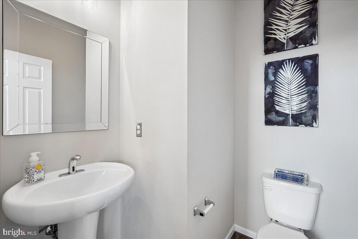 12268 Sedge Street Bristow, VA 20136 - Photo 13 of 48 a bathroom with a sink a toilet and mirror