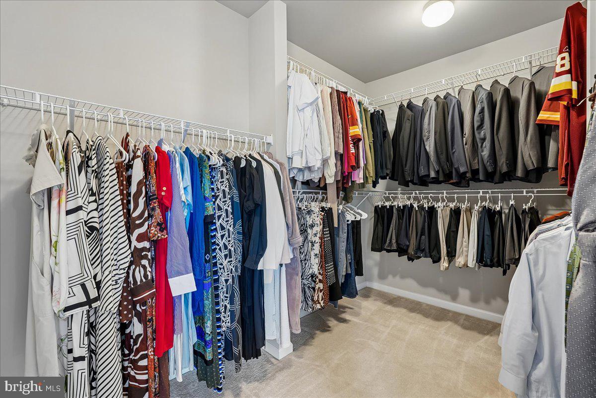 12268 Sedge Street Bristow, VA 20136 - Photo 18 of 48 a view of walk in closet with clothes