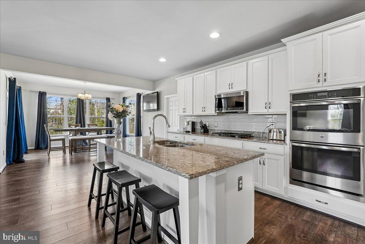12268 Sedge Street Bristow, VA 20136 - Photo 2 of 48 a kitchen with a stove a sink and a microwave