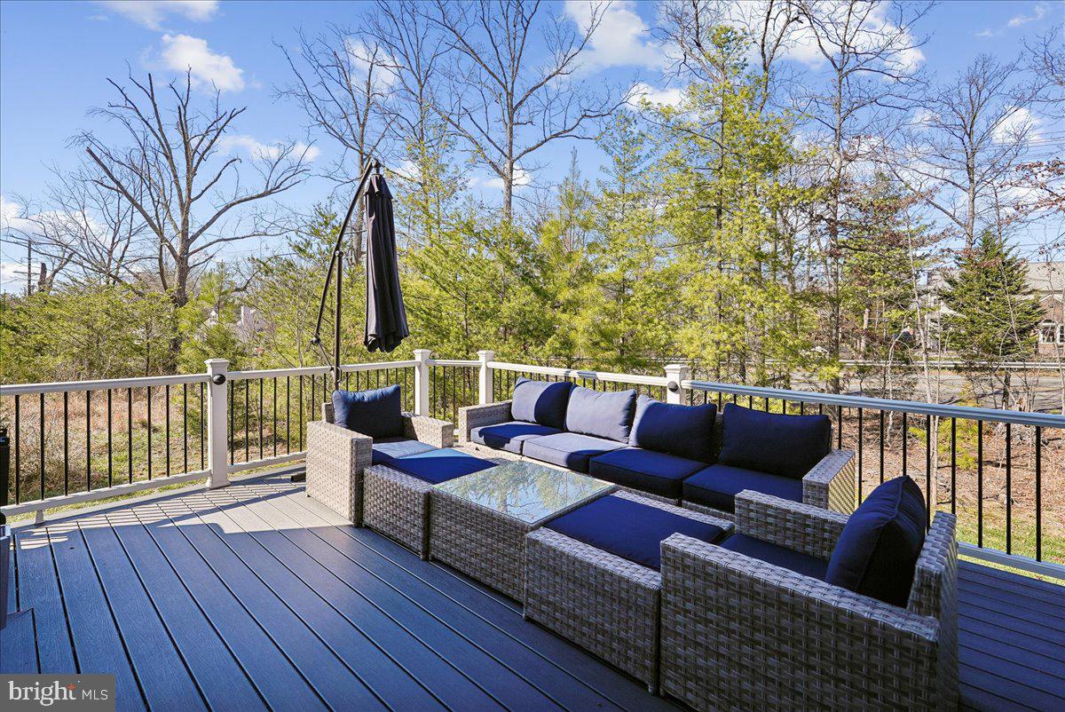 12268 Sedge Street Bristow, VA 20136 - Photo 32 of 48 a roof deck with couches and wooden floor