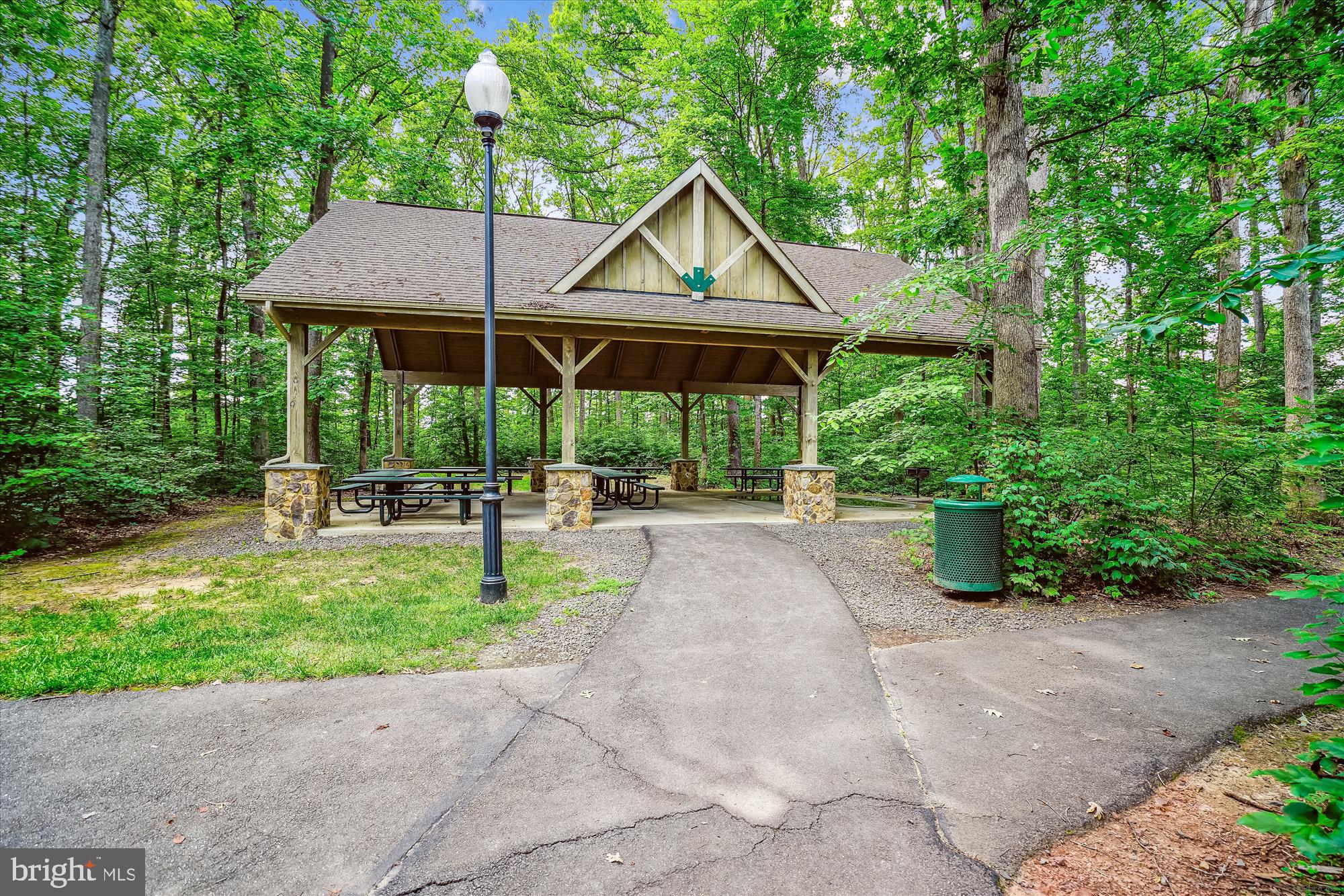 12268 Sedge Street Bristow, VA 20136 - Photo 40 of 48 a view of patio with a table and chairs under an umbrella
