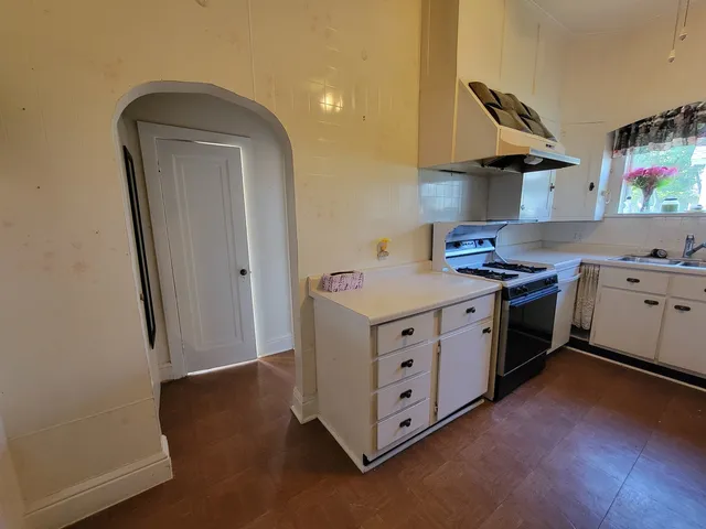 a kitchen with stainless steel appliances a stove a sink and a refrigerator
