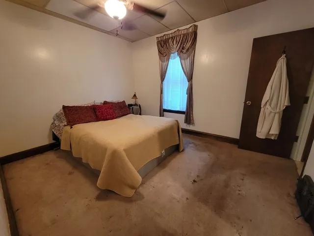 a bedroom with a bed and a mirror
