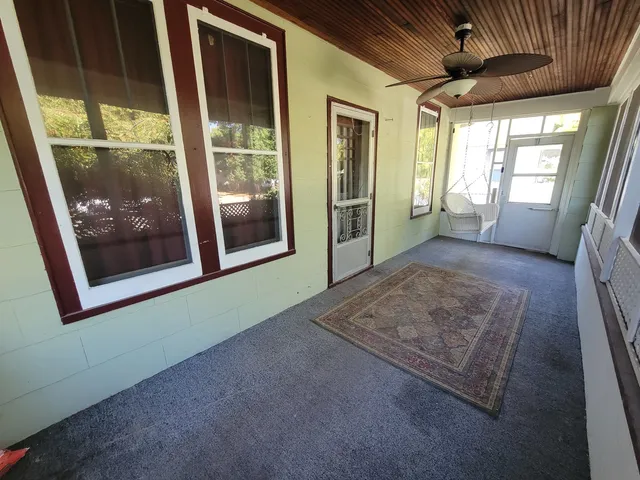 a view of hallway with wooden floor and door