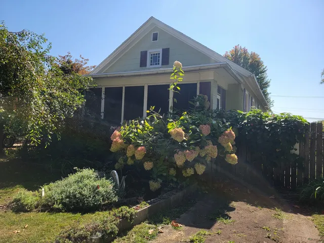a view of a backyard with a small cabin and a chair