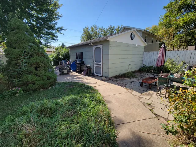 a view of backyard with table and chairs and potted plants