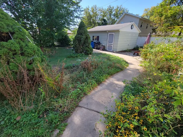 a view of a backyard with plants and a patio