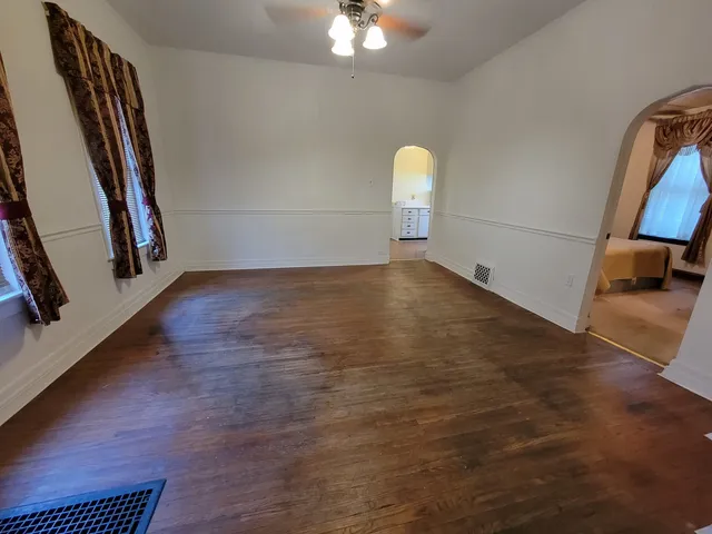 a view of a room with wooden floor and white walls