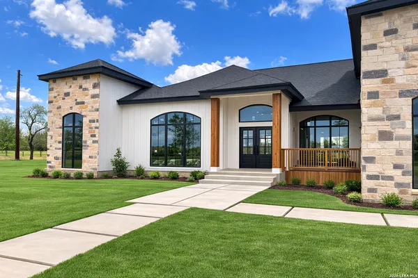 a view of a brick house with a yard