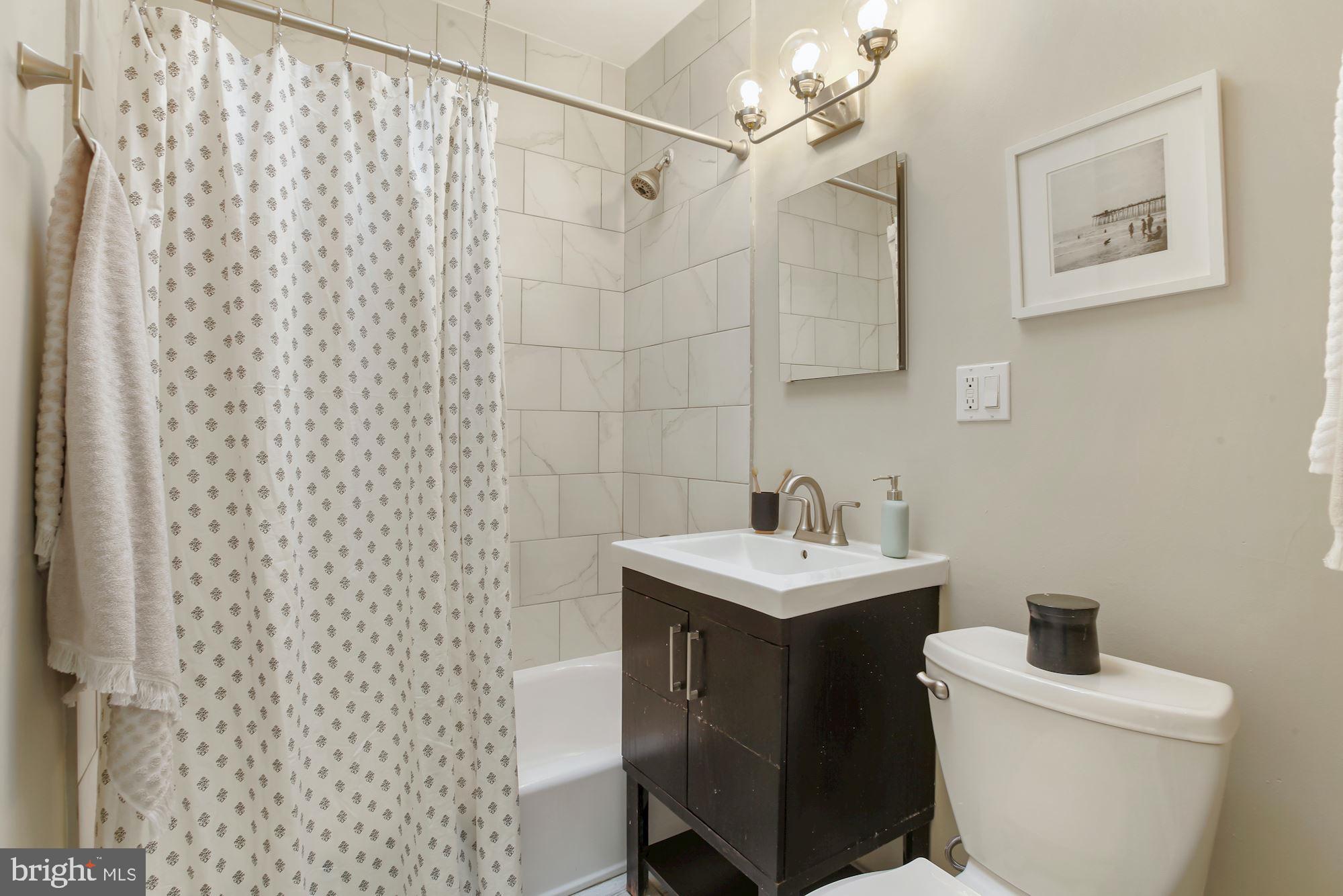 1328 Ridge Place Southeast Washington, DC 20020 - Photo 19 of 28 Upstairs bath w/new light fixture & tub reglaze