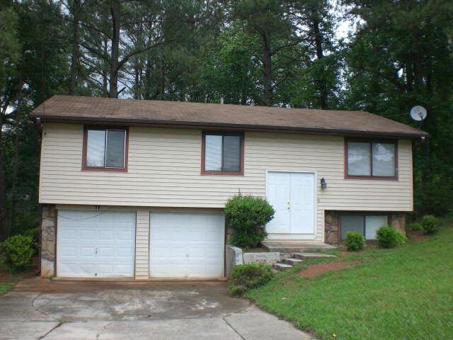 4664 Big Valley Road Stone Mountain, GA 30083 - Photo 1 of 1 a front view of a house with a garden
