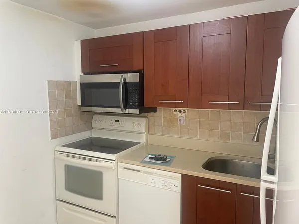 a kitchen with a stove microwave and sink