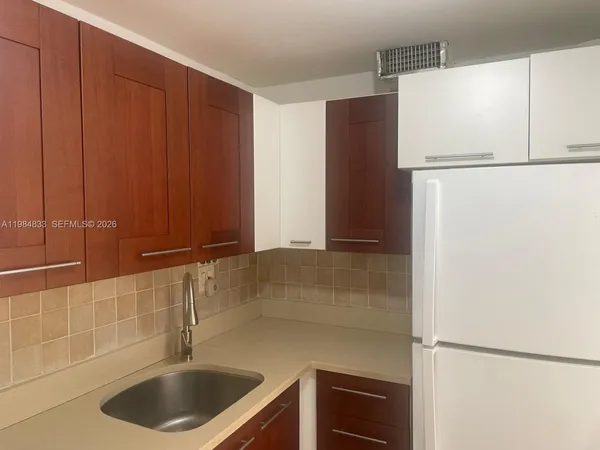 a kitchen with a sink and a refrigerator