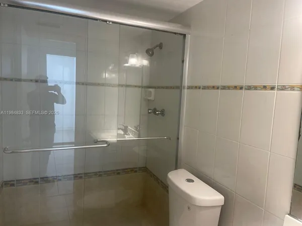 a bathroom with a toilet and a shower