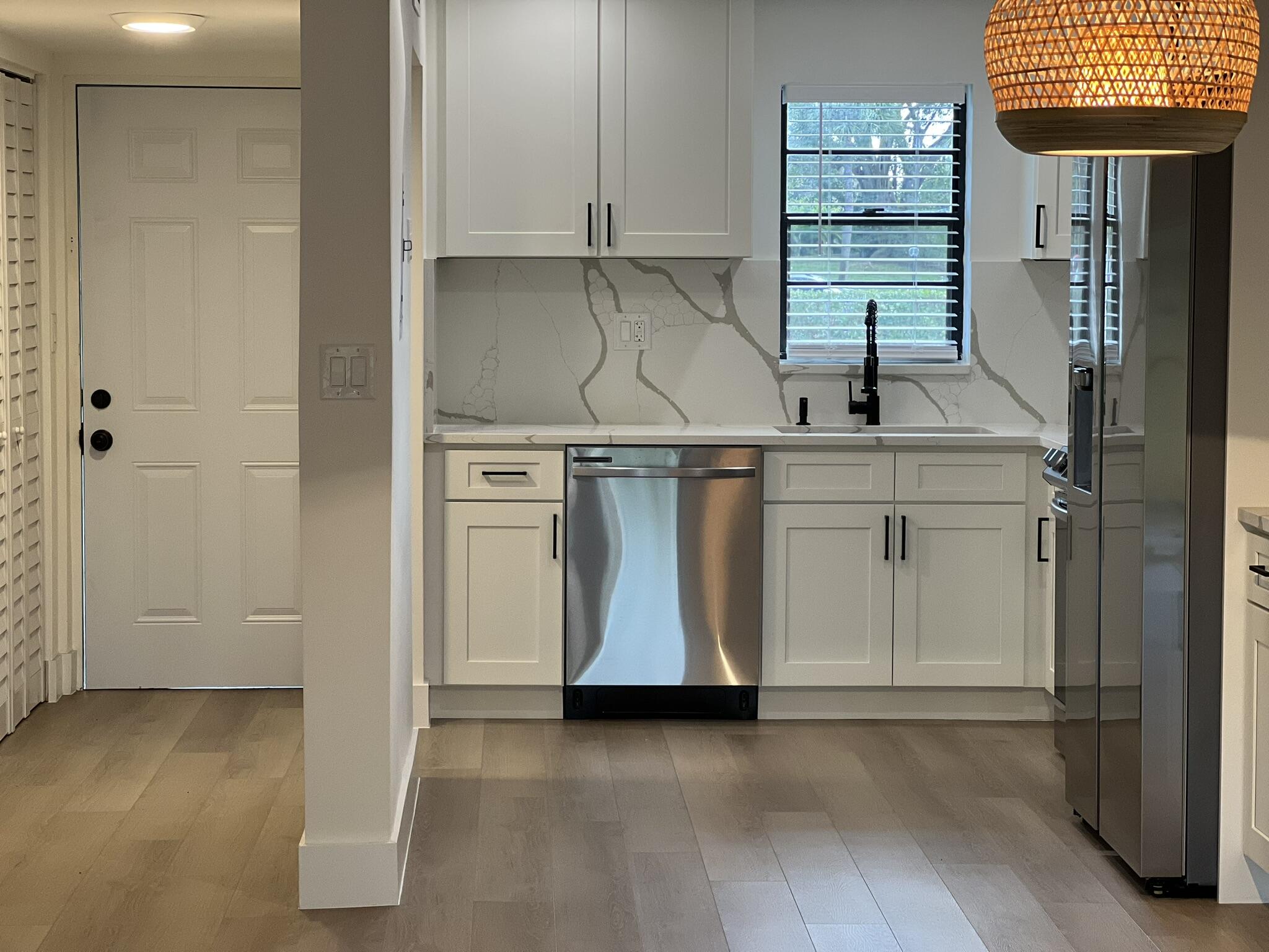 9235 Southwest 8th Street, Unit 106 Boca Raton, FL 33428 - Photo 3 of 27 a kitchen with a sink cabinets and a window