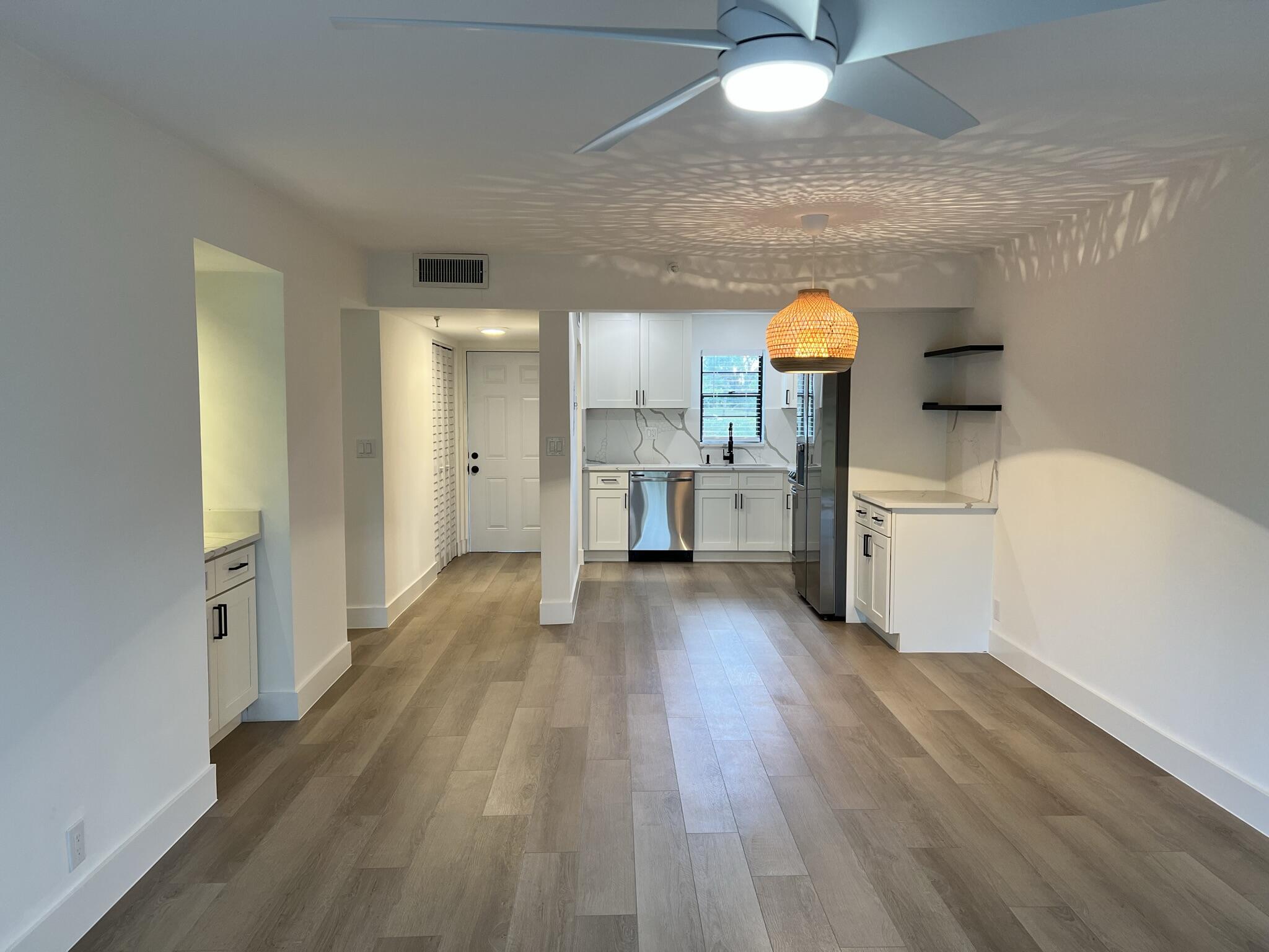 9235 Southwest 8th Street, Unit 106 Boca Raton, FL 33428 - Photo 7 of 27 a view of a kitchen and a sink cabinet fire place