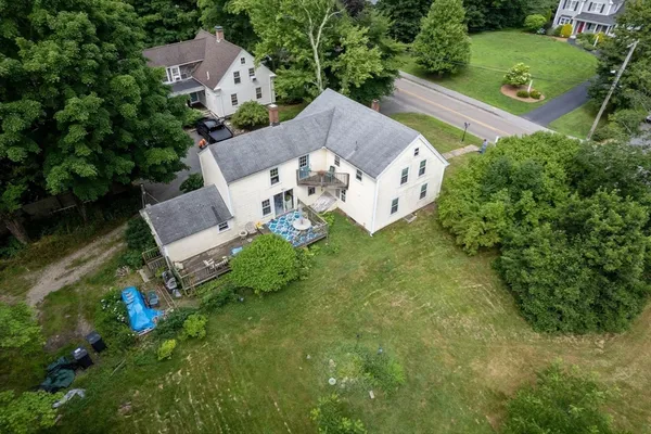 an aerial view of a house with a yard