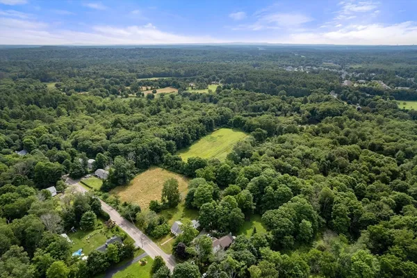 an aerial view of a house with a yard
