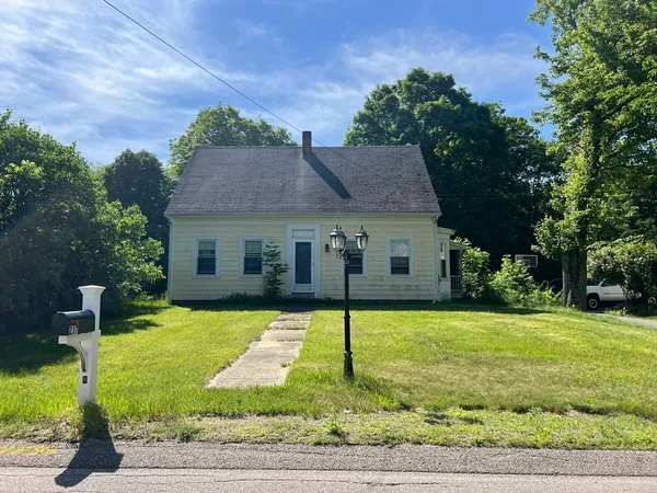 a view of a house with a yard and tree s