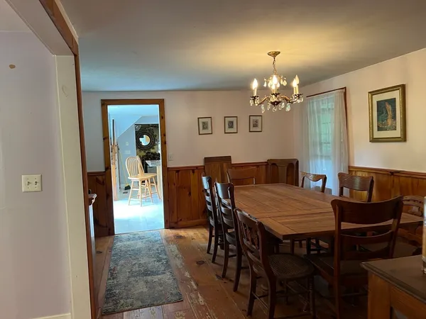 a view of a dining room with furniture and chandelier
