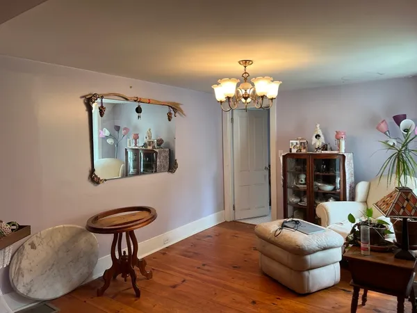 a living room with furniture and a chandelier