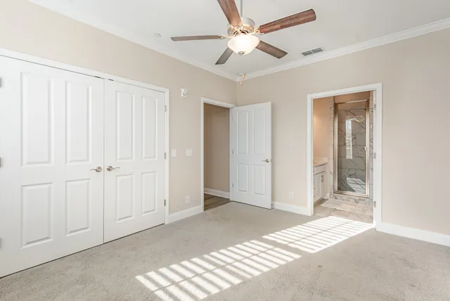 a view of a big room with closet and a ceiling fan