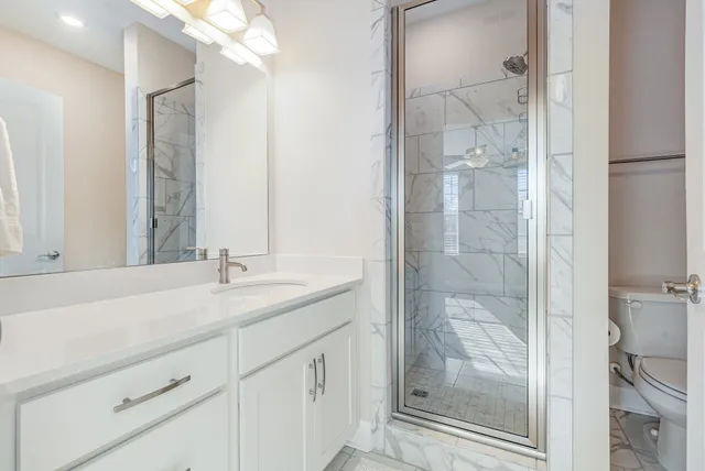 a bathroom with a shower sink and mirror