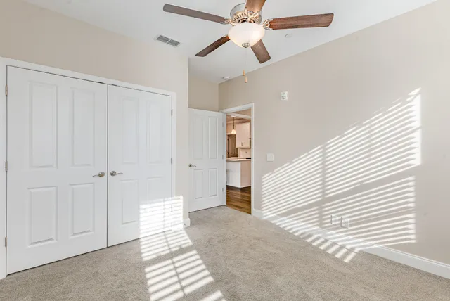 a view of a livingroom with a ceiling fan and window