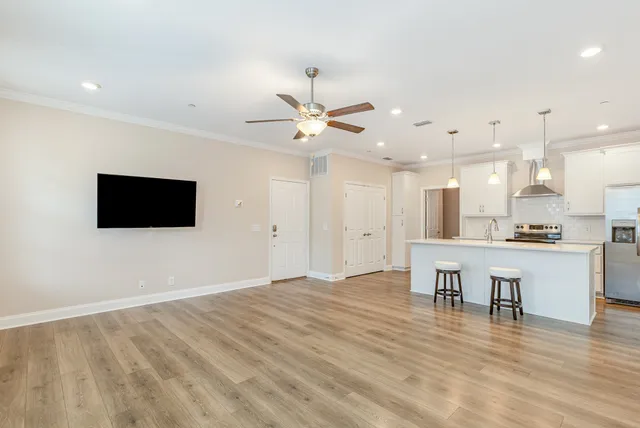 a view of kitchen with wooden floor and a sink