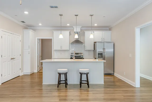 a large kitchen with a table and chairs