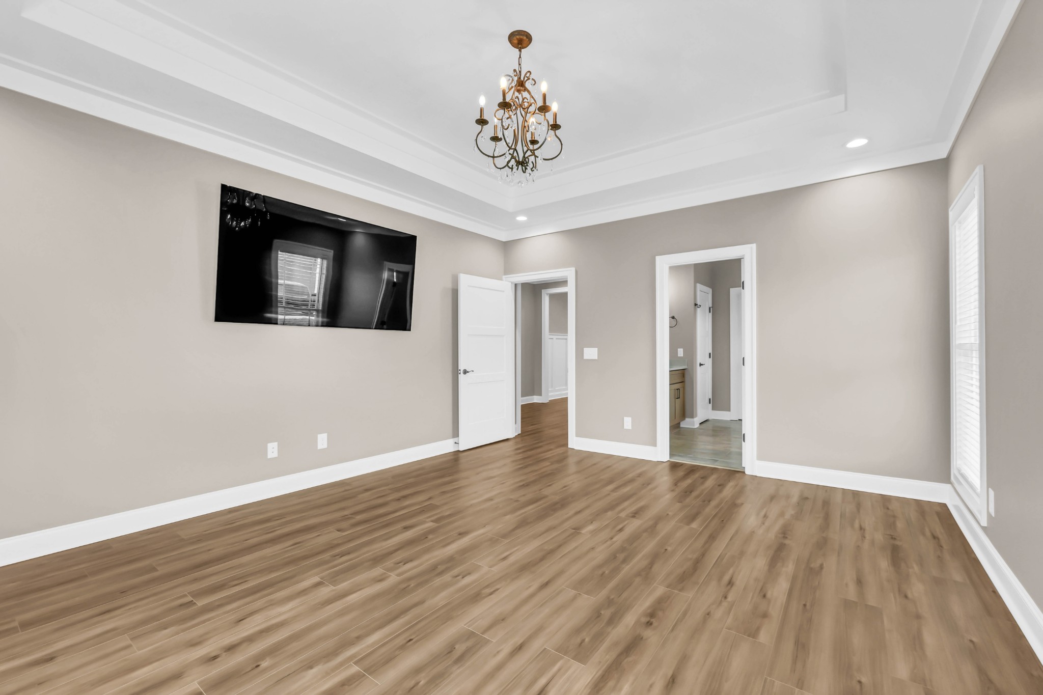 282 Martha Morgan Way Cunningham, TN 37052 - Photo 17 of 36 a view of an empty room with wooden floor and a ceiling fan