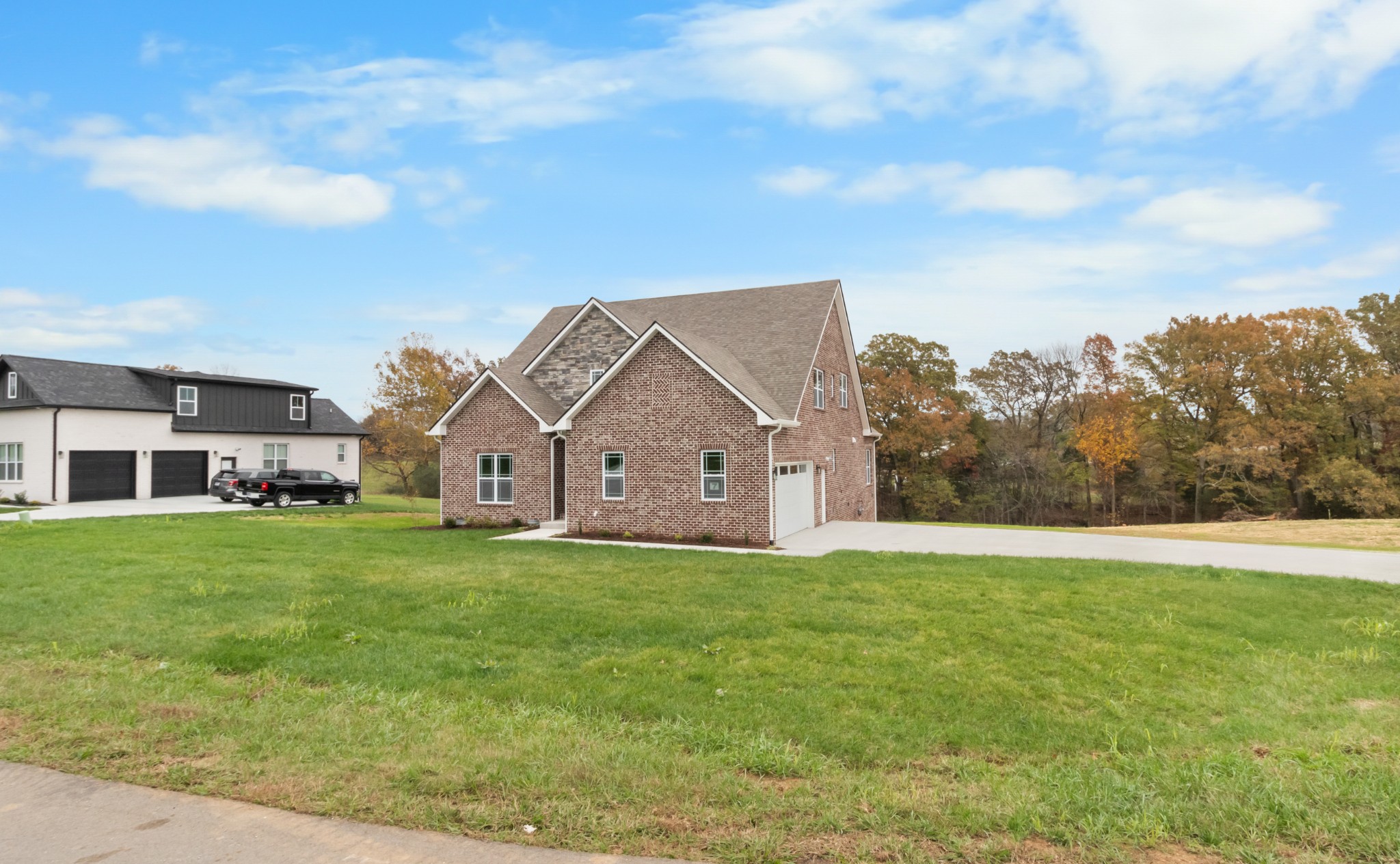282 Martha Morgan Way Cunningham, TN 37052 - Photo 3 of 36 a view of a big house with a big yard and large trees