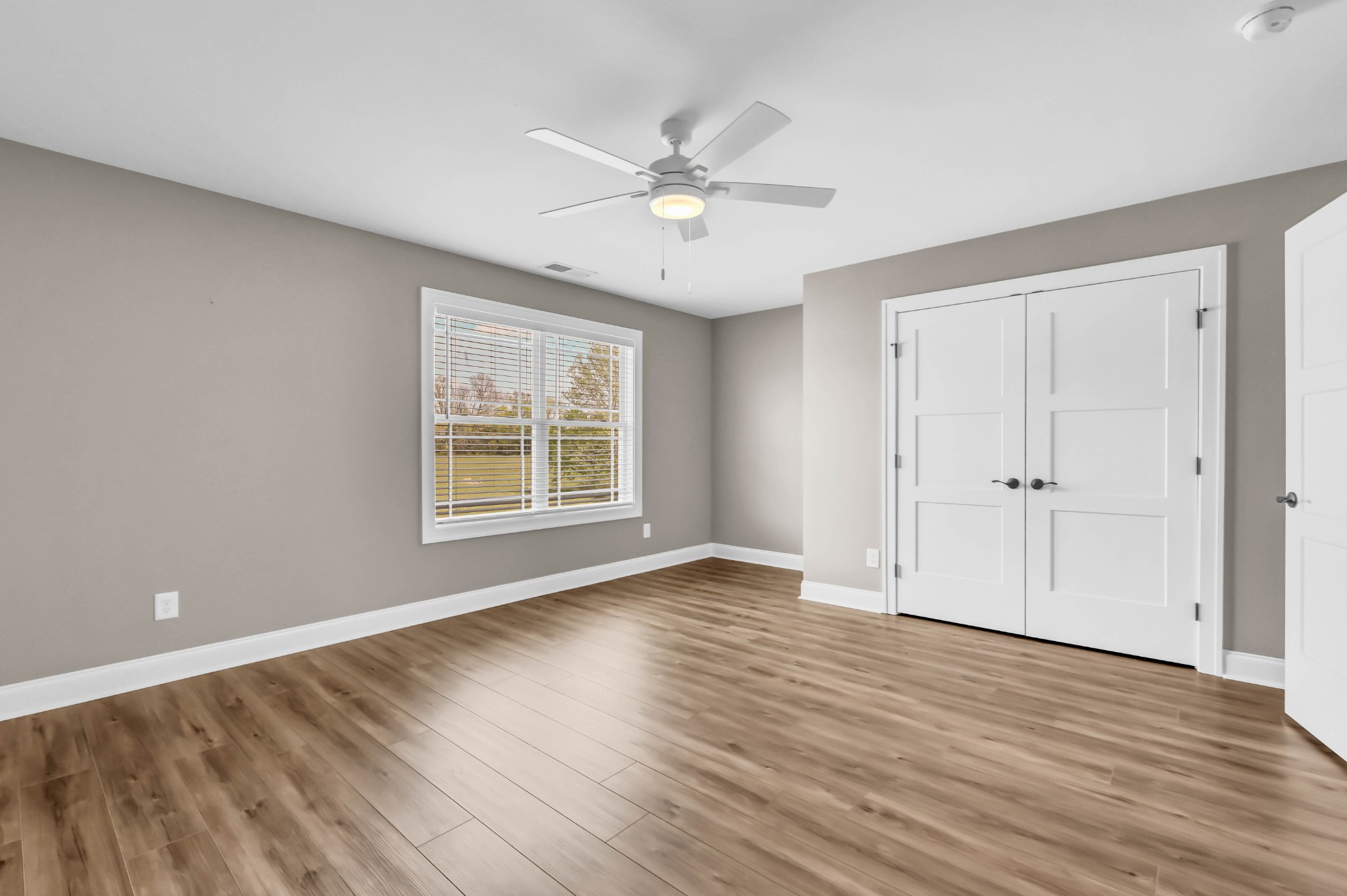 282 Martha Morgan Way Cunningham, TN 37052 - Photo 32 of 36 a view of an empty room with wooden floor and a window
