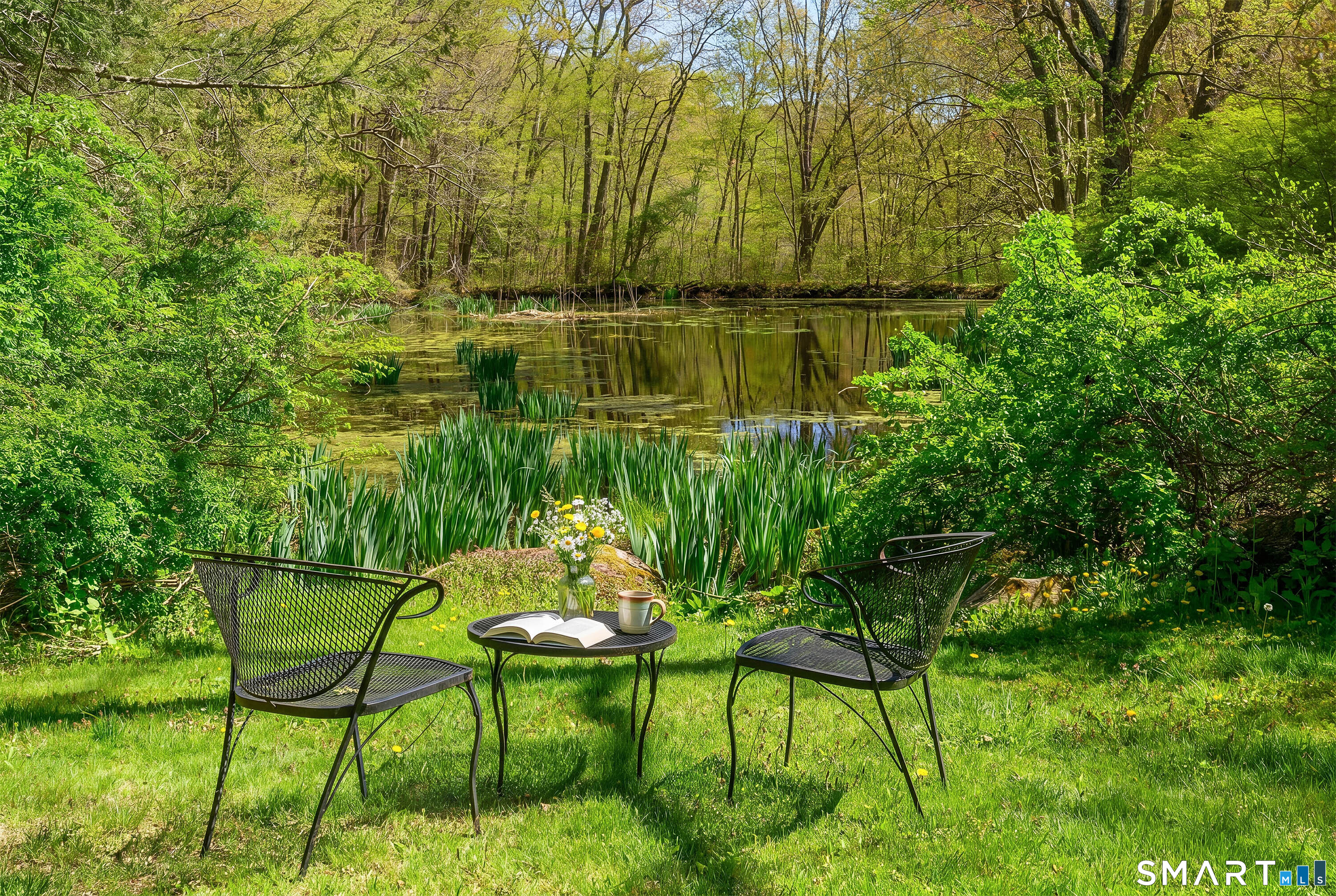 6 High Rock Road Newtown, CT 06482 - Photo 8 of 40 a backyard of a house with table and chairs and wooden fence