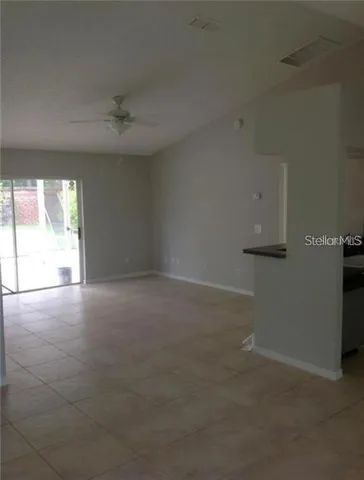 an empty room with a empty space and windows