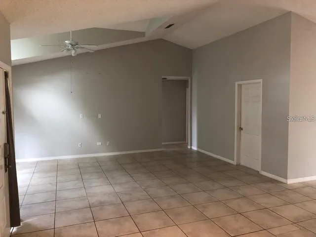 an empty room with white walls and tiles