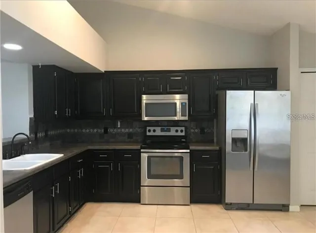 a kitchen with a sink and a refrigerator