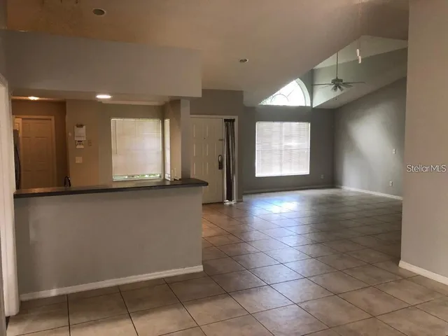 an empty room with windows and cabinet