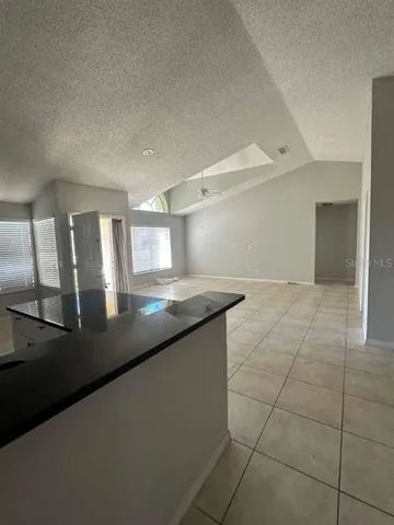 a kitchen with granite countertop a sink and a stove top oven