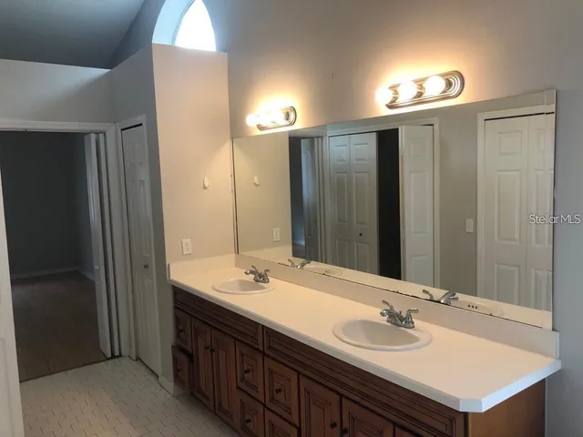 a bathroom with a sink double vanity and a mirror
