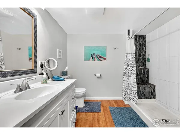 a bathroom with a sink a mirror and a shower