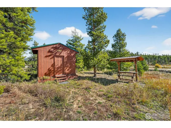 a backyard of a house with a table and chairs