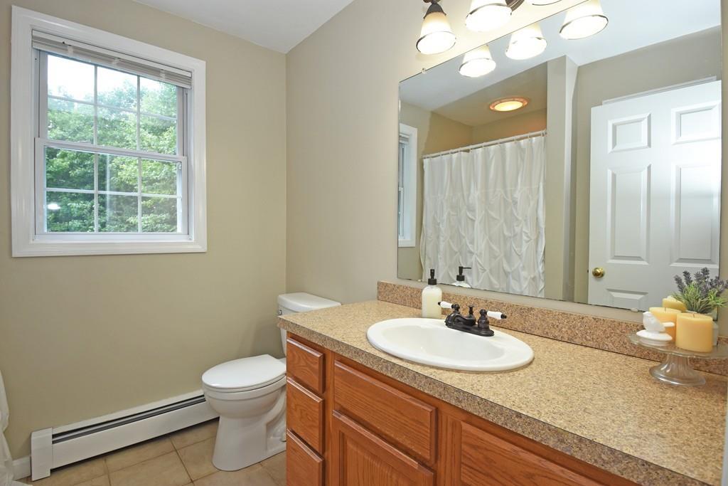 253 Pommogussett Road Rutland, MA 01543 - Photo 14 of 25 a bathroom with a granite countertop sink a toilet and a mirror