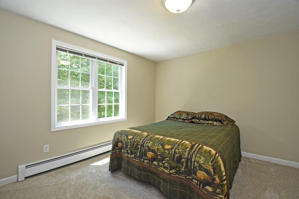 253 Pommogussett Road Rutland, MA 01543 - Photo 18 of 25 a bed sitting in a bedroom next to a window