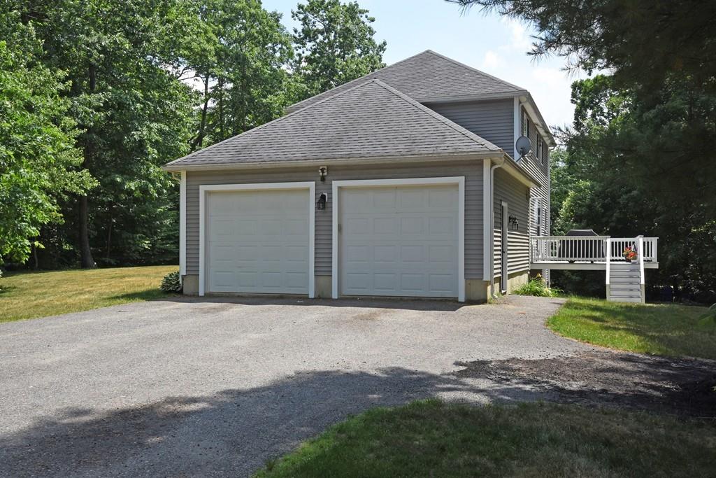 253 Pommogussett Road Rutland, MA 01543 - Photo 21 of 25 a front view of a house with a yard and garage